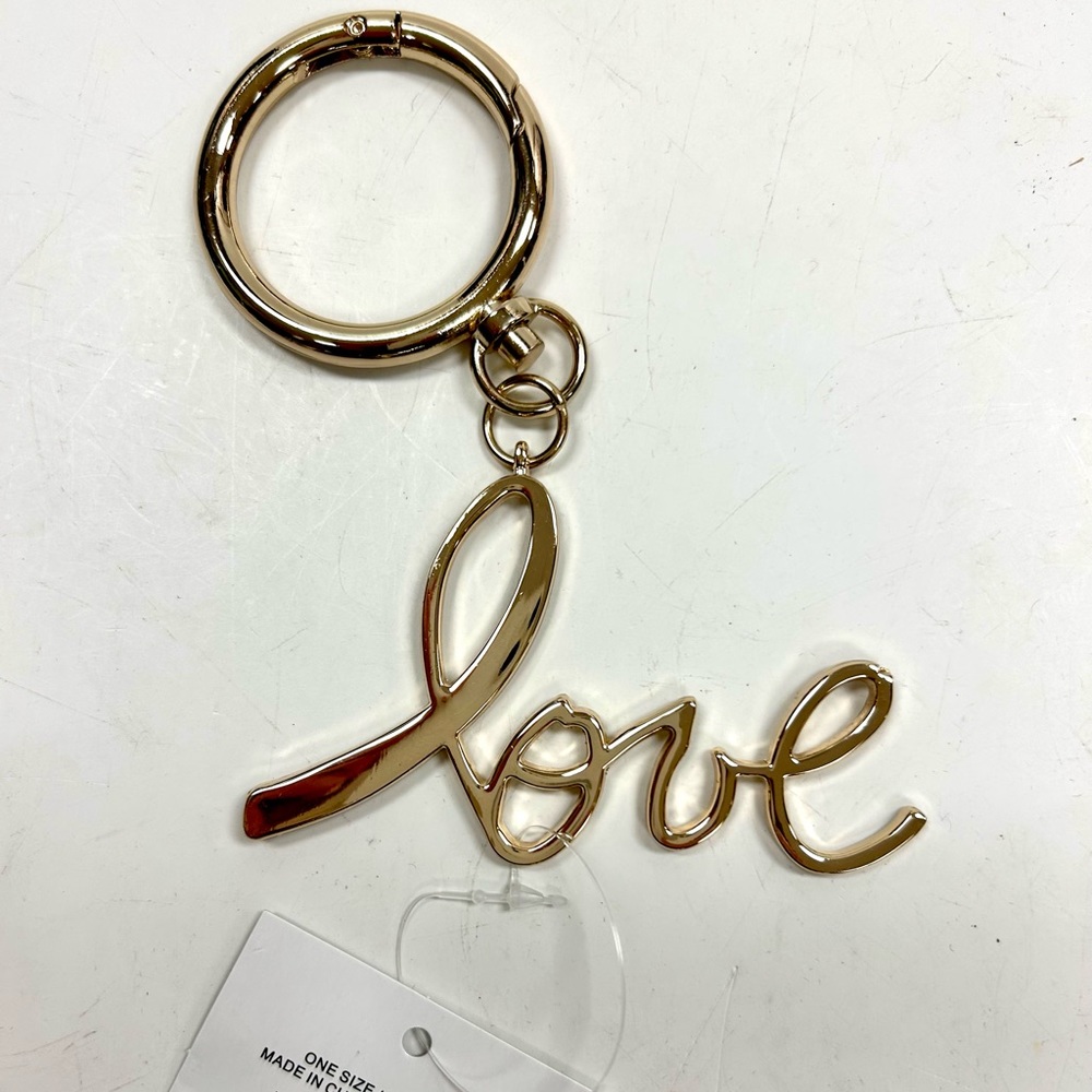 Here is a set of 13 New Avon Goldtone LOVE Bag Charms